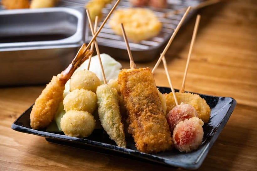 Osaka: Food Tour Kuromon Market & Dotonbori with Guide - Dotonbori Neon Walk and Ebisu Bridge Glico Sign Photos