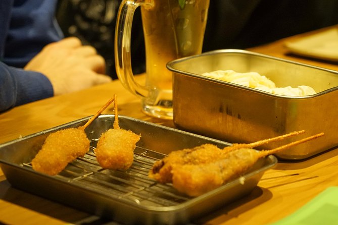 Osaka Local Foodie Walking Tour in Dotonbori and Shinsekai - Stop 1: Tsutenkaku and Jan-Jan Yokocho kushikatsu
